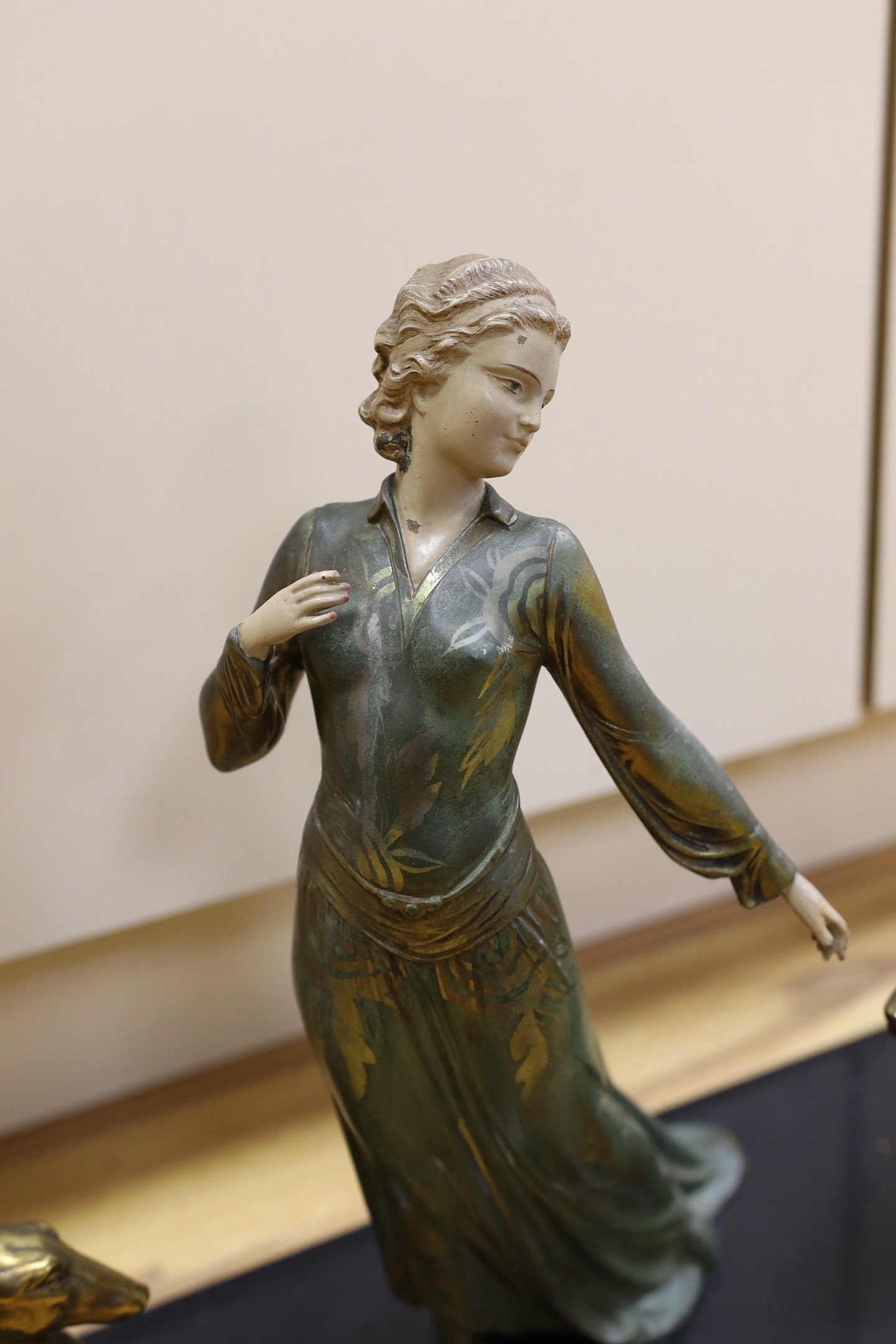 A French Art Deco female spelter figure and two bronzed spelter dogs on black marble base, signed Roggia. 74cm wide